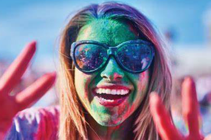 Happy young woman with paint on her face.